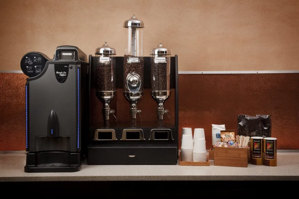 A premium bean-to-cup coffee brewer and fully stocked office coffee station provided by Amenity Now for a Charlotte workplace.
